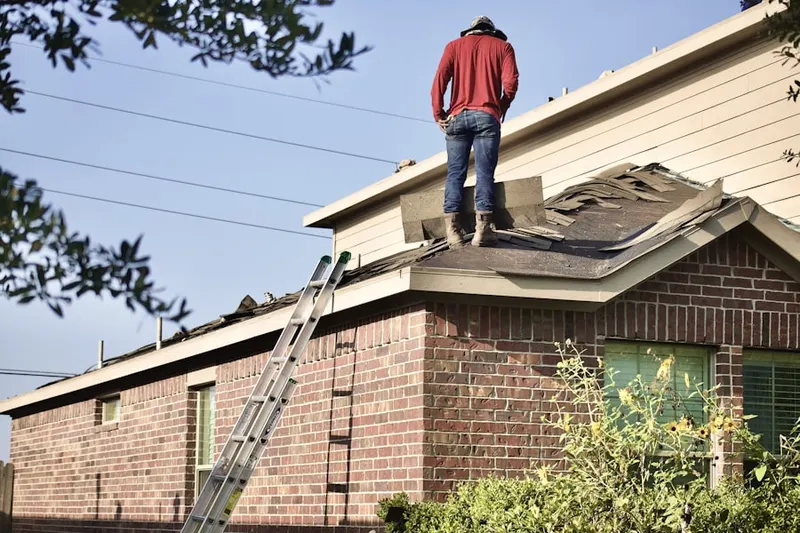 Professional roofer working on a residential roof in Buck Run
